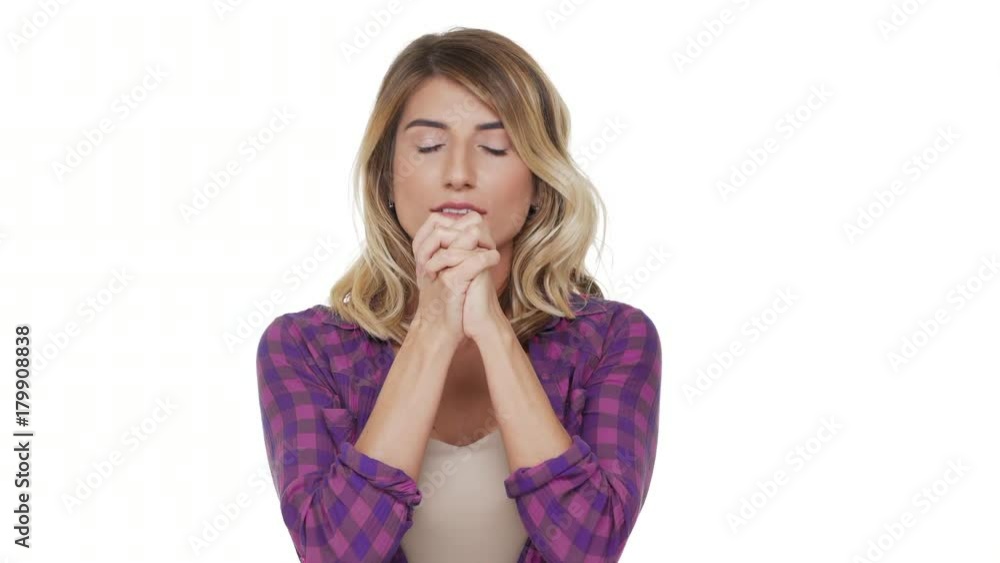 portrait of serious woman with brown eyes and dyed hair looking up with keeping hands in praying begging god please wishing something strongly over white background. Concept of emotions portrait of serious woman with brown eyes and dyed hair looking up with keeping hands in praying begging god please wishing something strongly over white background. Concept of emotions