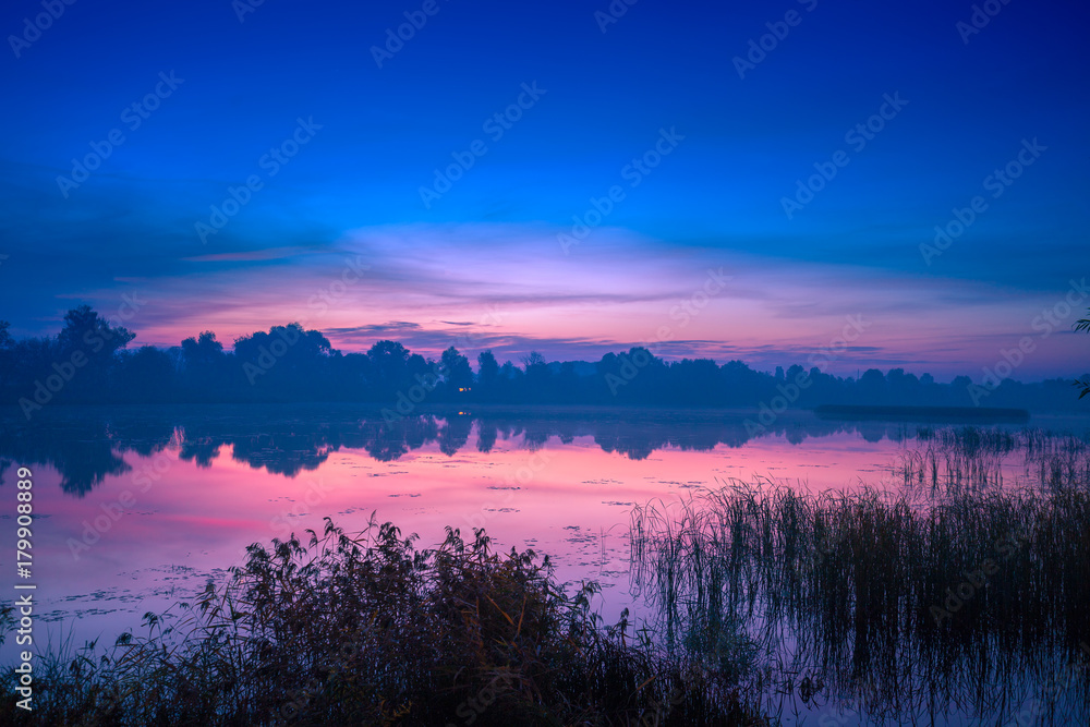 Early morning, dawn over the lake. Misty morning, rural landscape, wilderness, mystical feeling