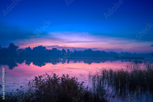 Early morning, dawn over the lake. Misty morning, rural landscape, wilderness, mystical feeling