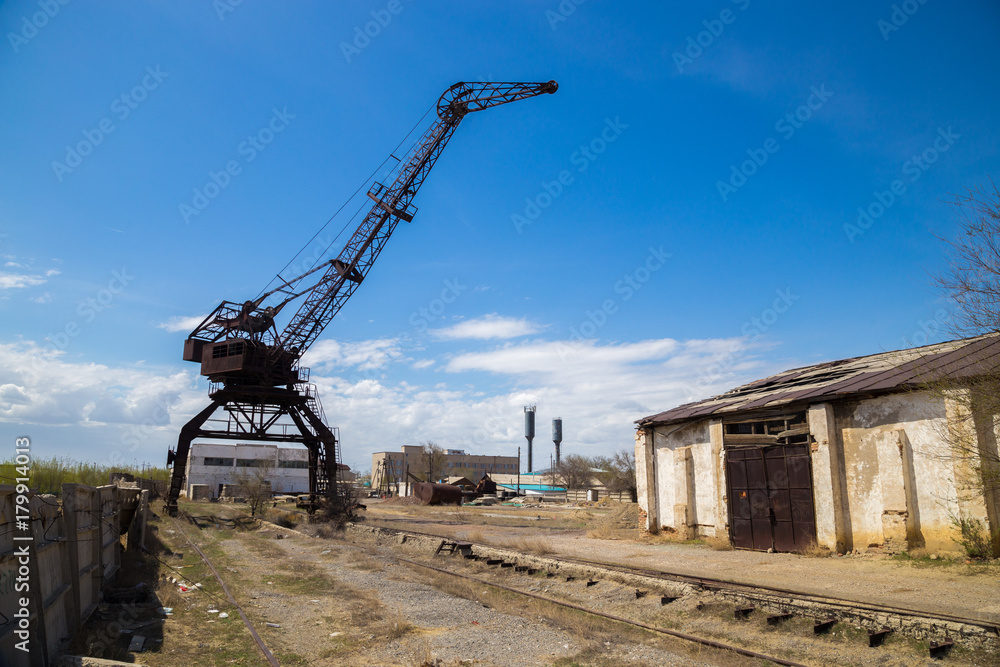 Old rusty crane in abandoned industrial area. 