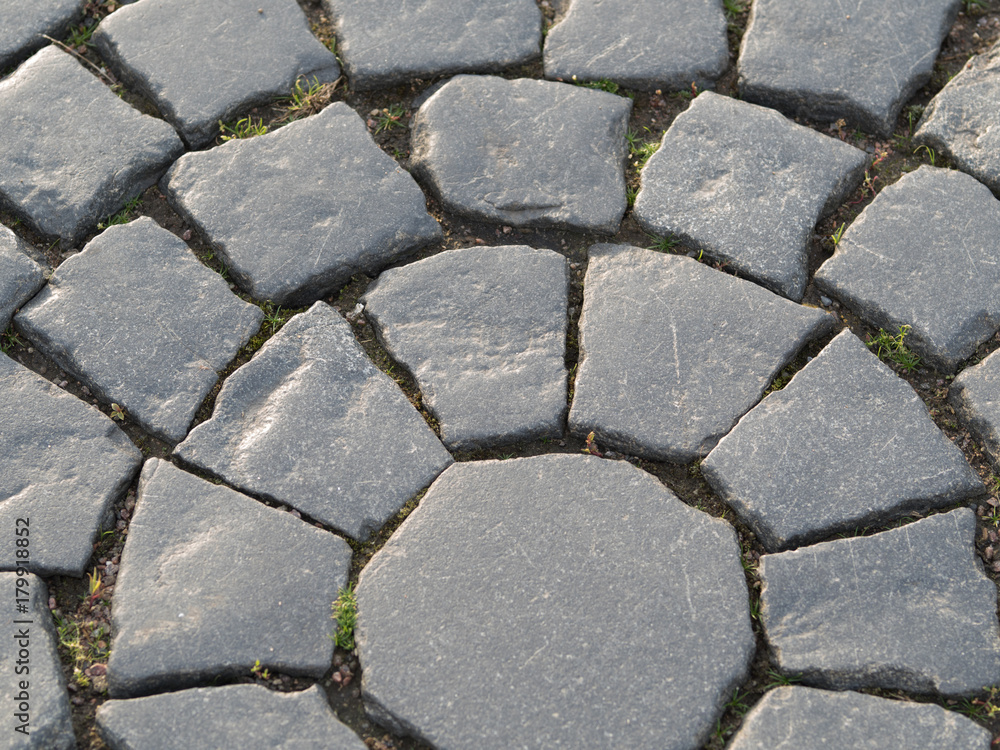 Obraz premium The texture of a street cobblestone road. Texture background