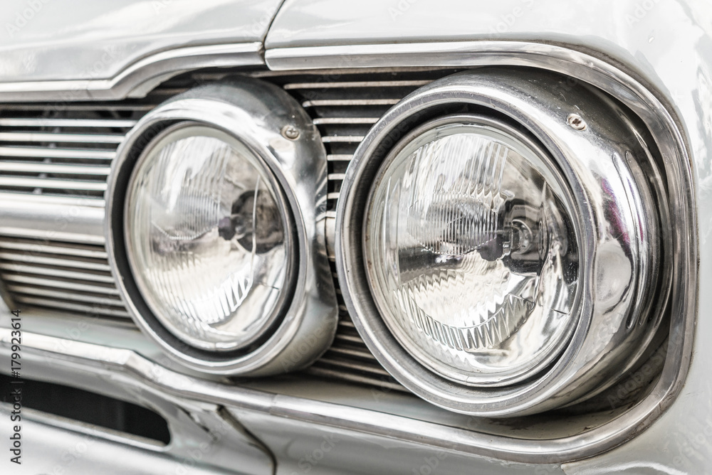 Headlight of a vintage retro old car automobile vehicle