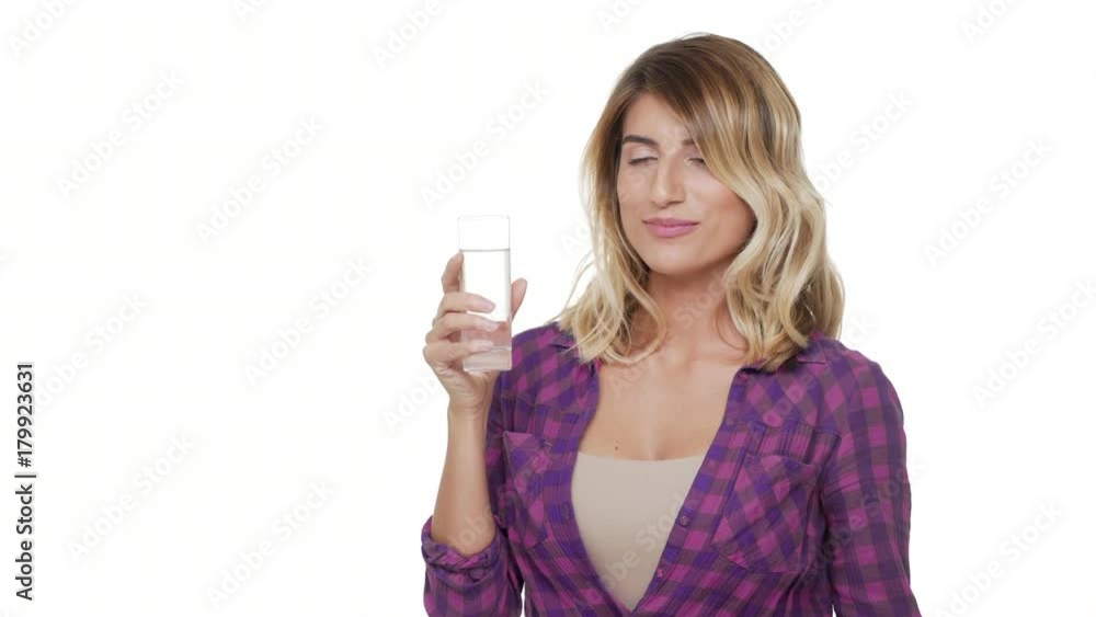 half-turn portrait of attractive woman with trendy hair wearing casual clothes drinking water from glass being thirsty over white background copy space. Concept of emotions half-turn portrait of attractive woman with trendy hair wearing casual clothes drinking water from glass being thirsty over white background copy space. Concept of emotions