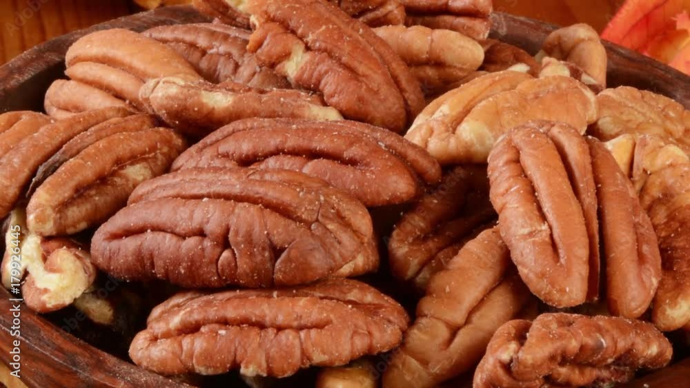 Zoom out shot of a bowl of pecans on a holiday table Zoom out shot of a bowl of pecans on a holiday table