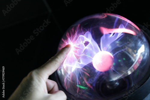 hand touching plasma globe
 photo