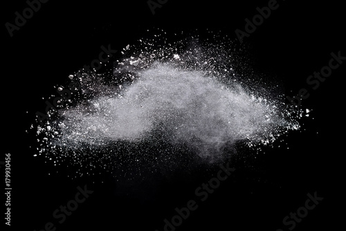 Freeze motion of white powder explosions isolated on black background © piyaphong