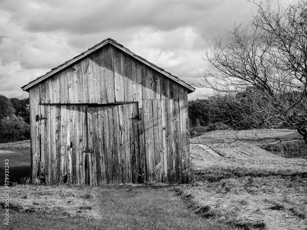 Abandoned weathered barn on a hillside Abandoned weathered barn on a hillside