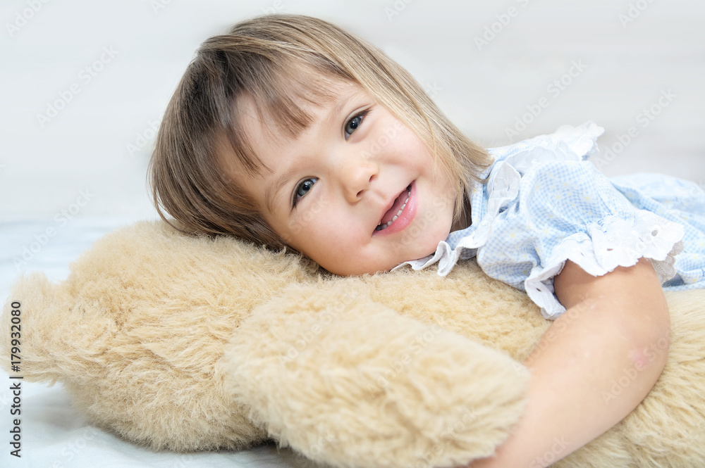 Little girl portrait happy smiling with Teddy bear hugging toy Little girl portrait happy smiling with Teddy bear hugging toy