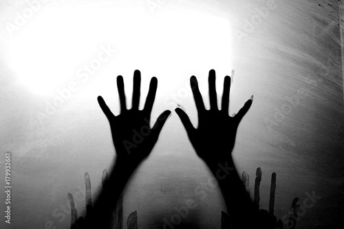 Horror woman hands. Diffused silhouette. Black and white.
