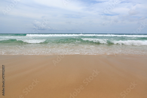 Surf wave and sea beach sand background.