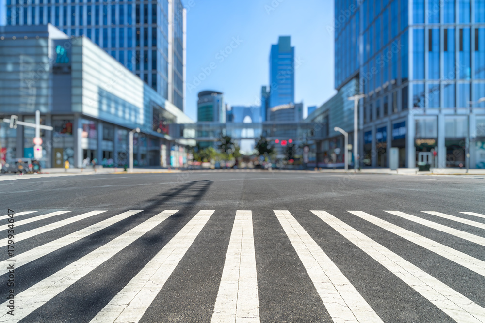 empty road with zebra crossing and skyscrapers in modern city. empty road with zebra crossing and skyscrapers in modern city.