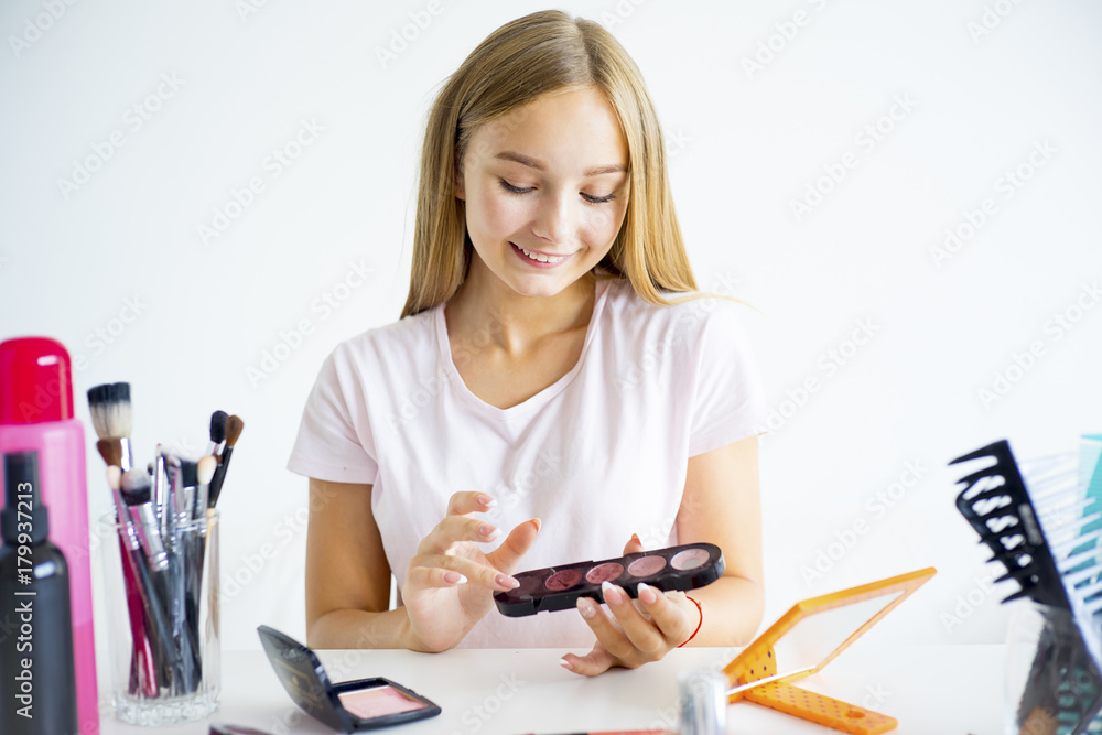 Girl applying makeup Girl applying makeup