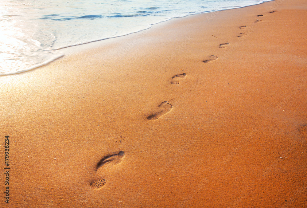 beach, wave and footprints at sunset time beach, wave and footprints at sunset time