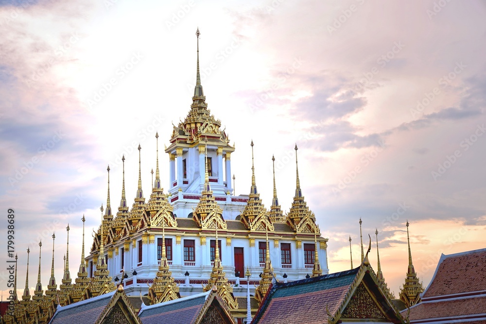 Fototapeta premium Loha Prasat , The metallic castle covered with gold leaf at of Wat Ratchanadda Temple in Bangkok, Thailand.