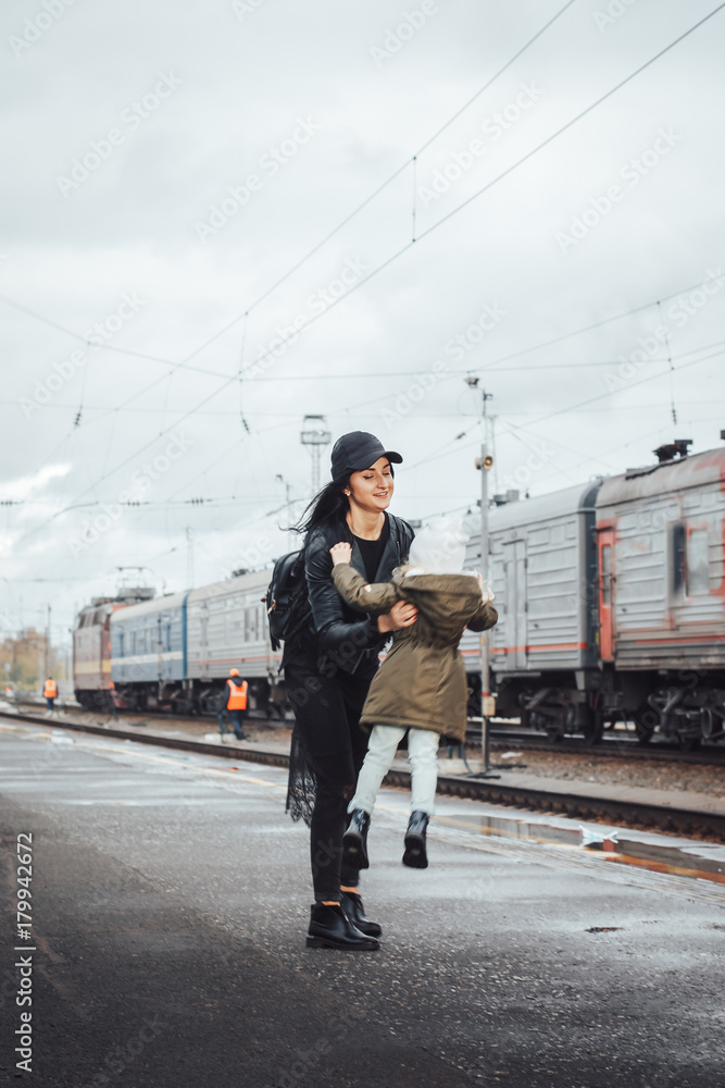 Mother and daughter at the train station Mother and daughter at the train station