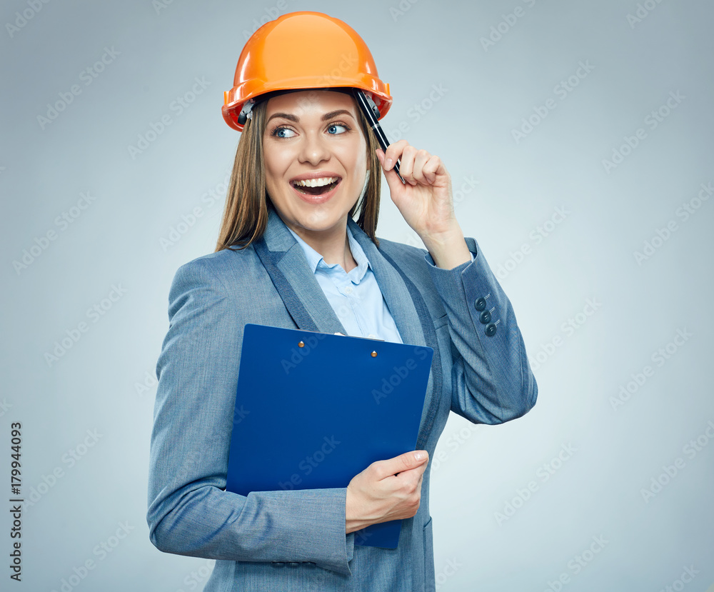 Thinking business woman builder holding clipboard with contract. Thinking business woman builder holding clipboard with contract.