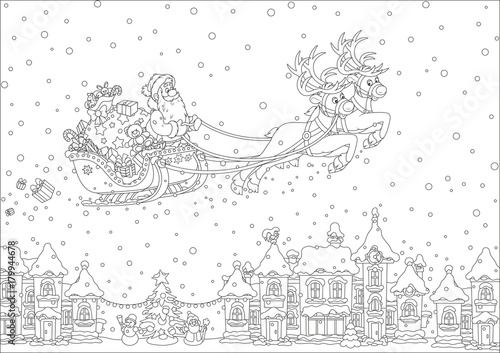 Magic reindeers flying Santa Claus with Christmas gifts over a snow-covered town on Christmas eve