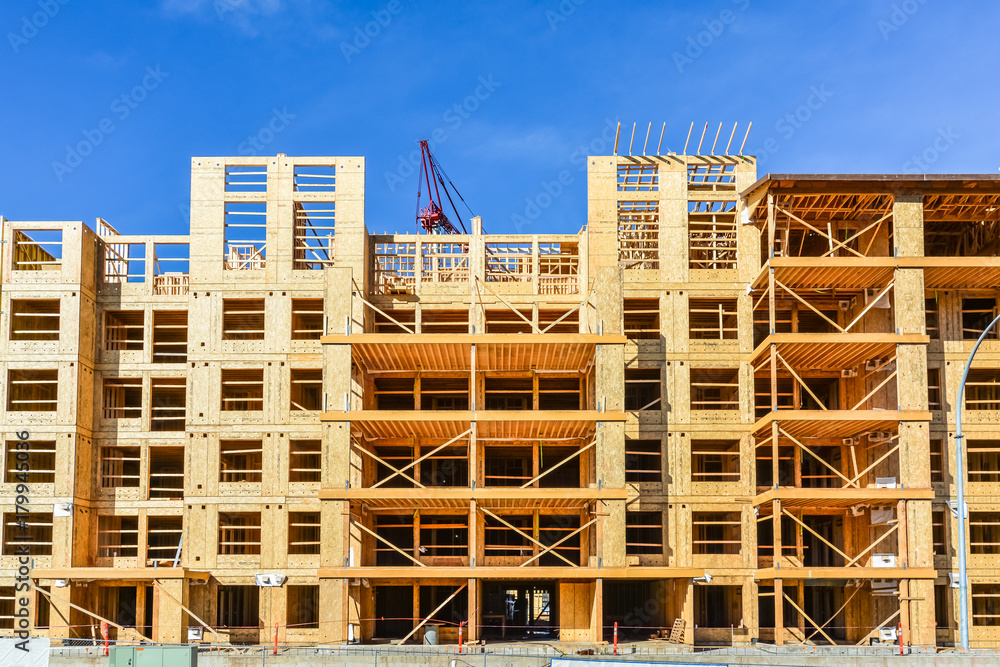 Six storey frame building under construction on concrete foundation bed Six storey frame building under construction on concrete foundation bed