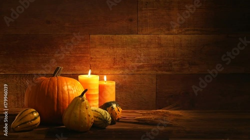 Autumn harvest Pumpkins and candles on retro wood background video