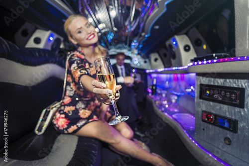 Travelling in style in a limousine with a glass of champagne