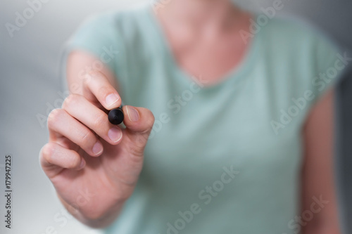 Businesswoman writing with a pen on a digital screen