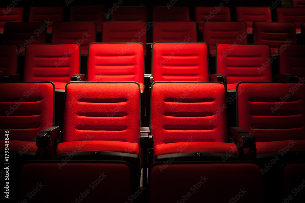 Obraz premium Red seat in the movie theater. Blurry background.