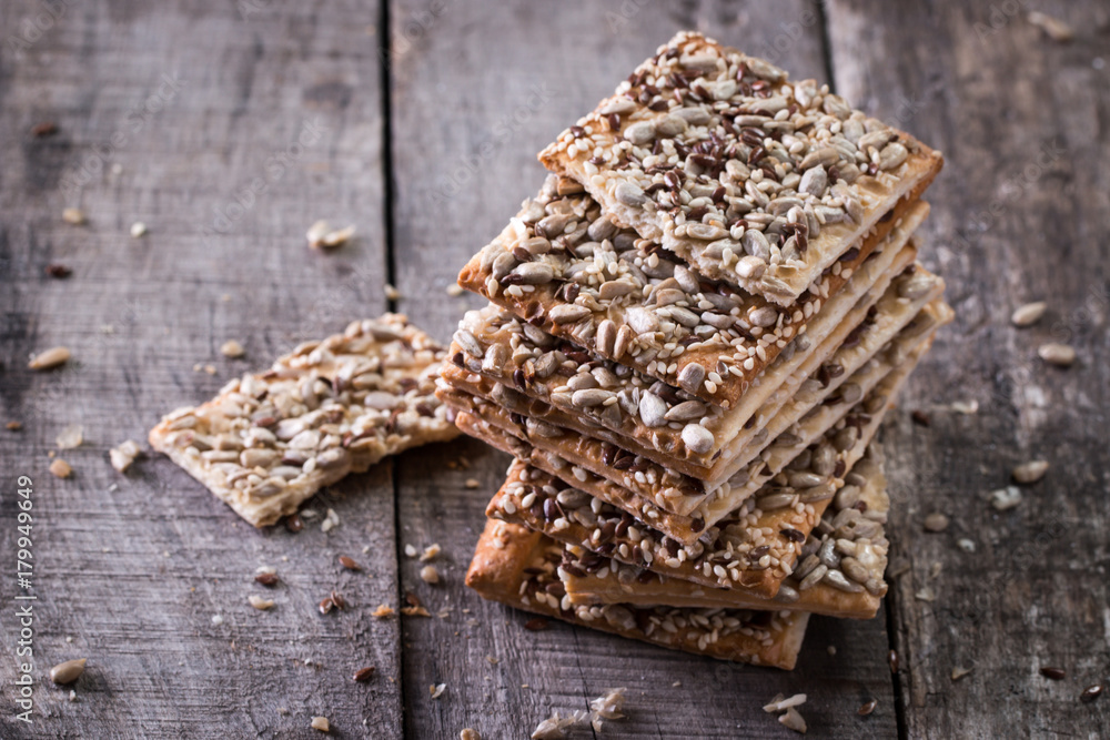 Crunchy crispbread on a wooden background. Healthy snack: cereal crunchy multigrain cereal flax seed ,sesame, sunflower seeds protein bread bar. Crunchy crispbread on a wooden background. Healthy snack: cereal crunchy multigrain cereal flax seed ,sesame, sunflower seeds protein bread bar.
