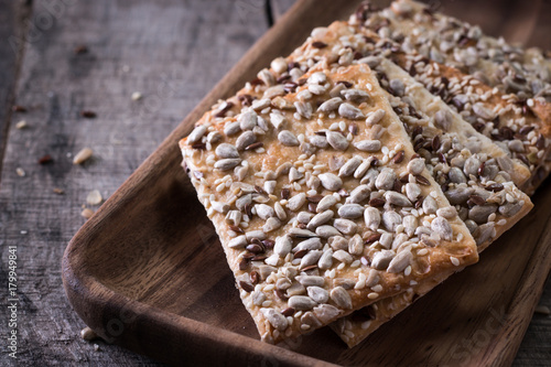 Crunchy crispbread on a wooden background. Healthy snack: cereal crunchy multigrain cereal flax seed ,sesame, sunflower seeds protein bread bar.