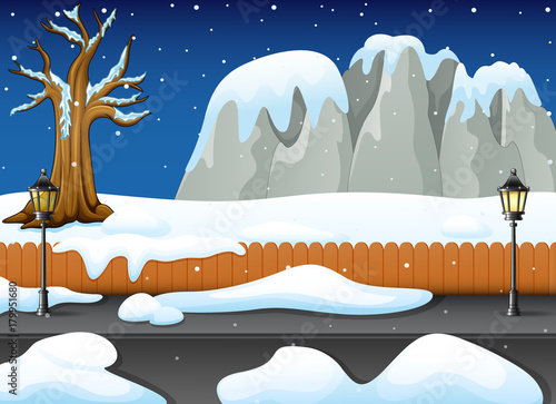 Winter night landscape with snowy rocks and snow on the street