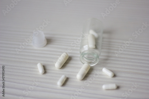 Glass bottle of white pills photo