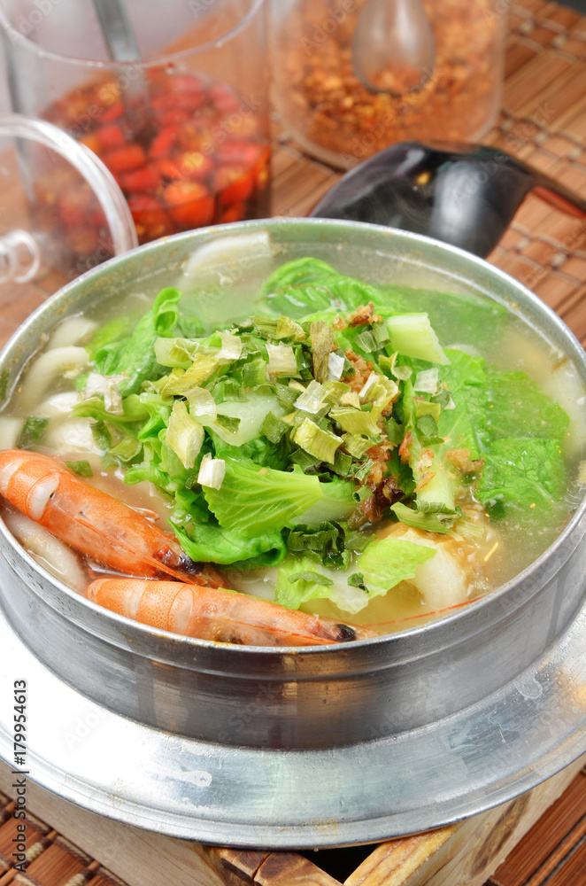 Japanese noodle dish nabeyaki udon with shrimp , egg and vegetables. Japanese noodle dish nabeyaki udon with shrimp , egg and vegetables.