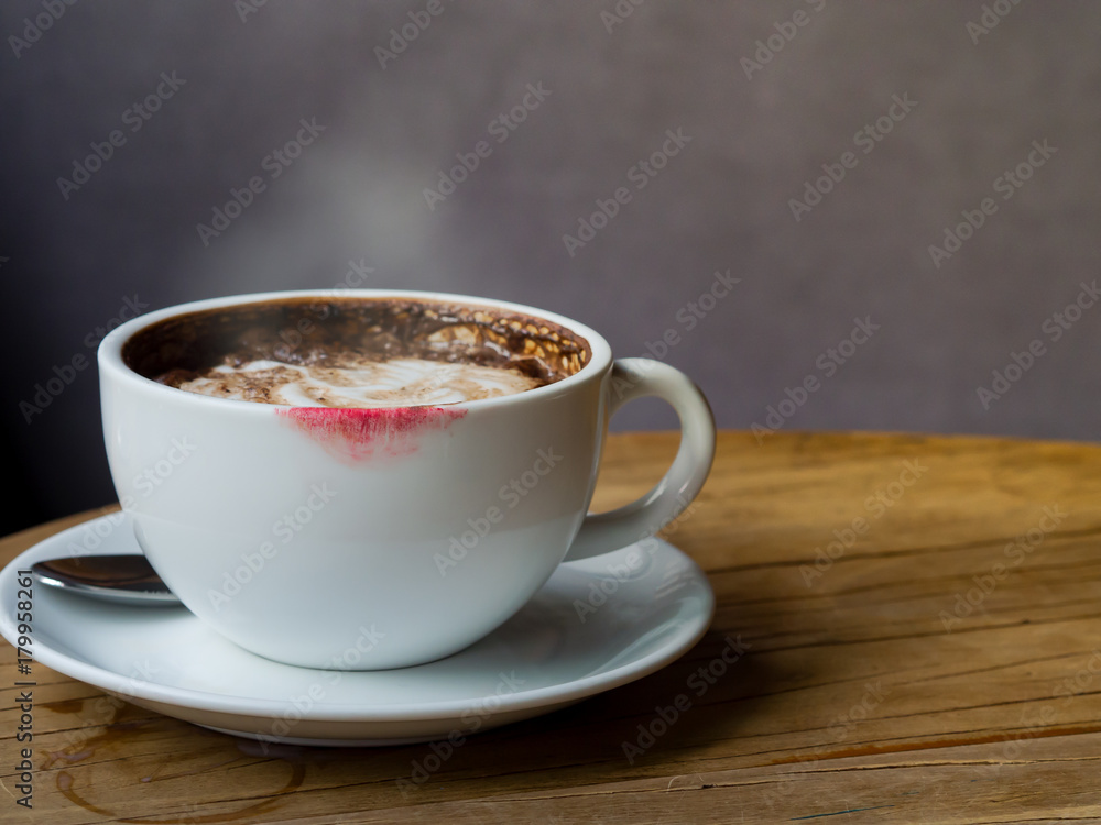 Hot coffee latte with latte art and white smoke in white coffee cup or mug  with red lipstick stain on wooden table at coffee shop Stock Photo | Adobe  Stock