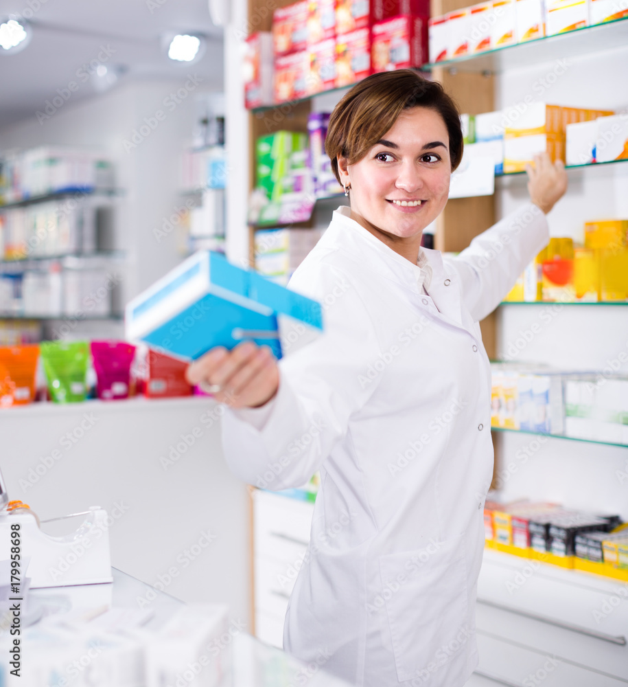 Professional pharmacist girl is showing right drug