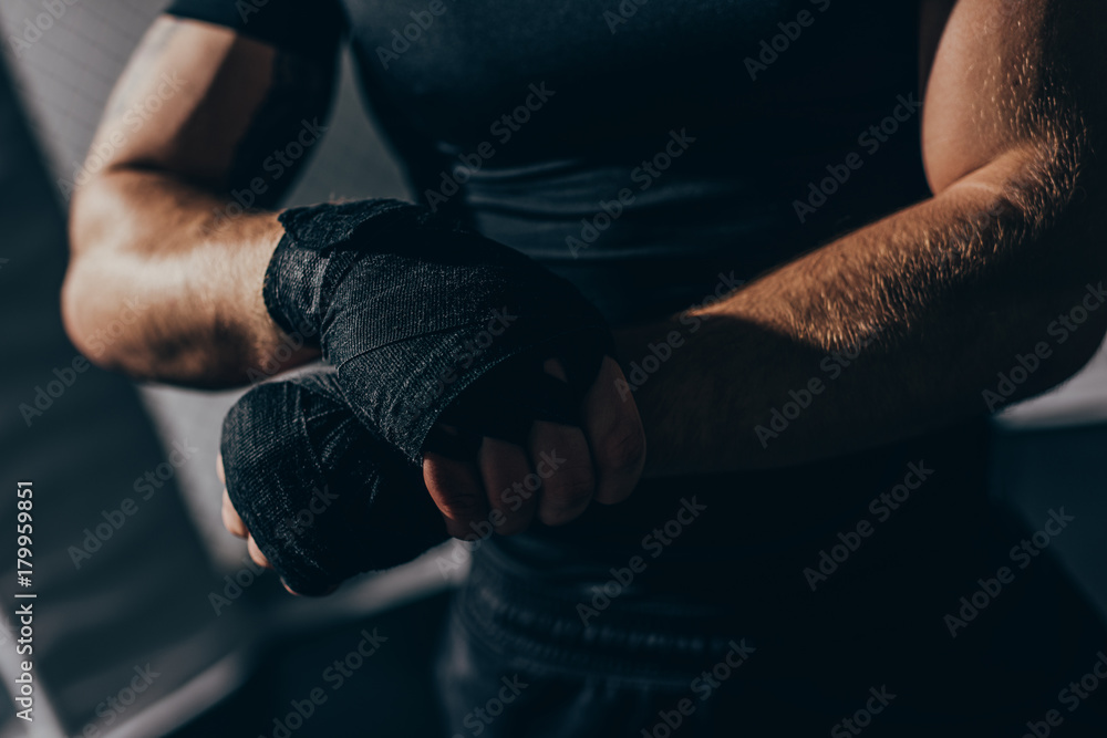 boxer wrapping hands with bandages