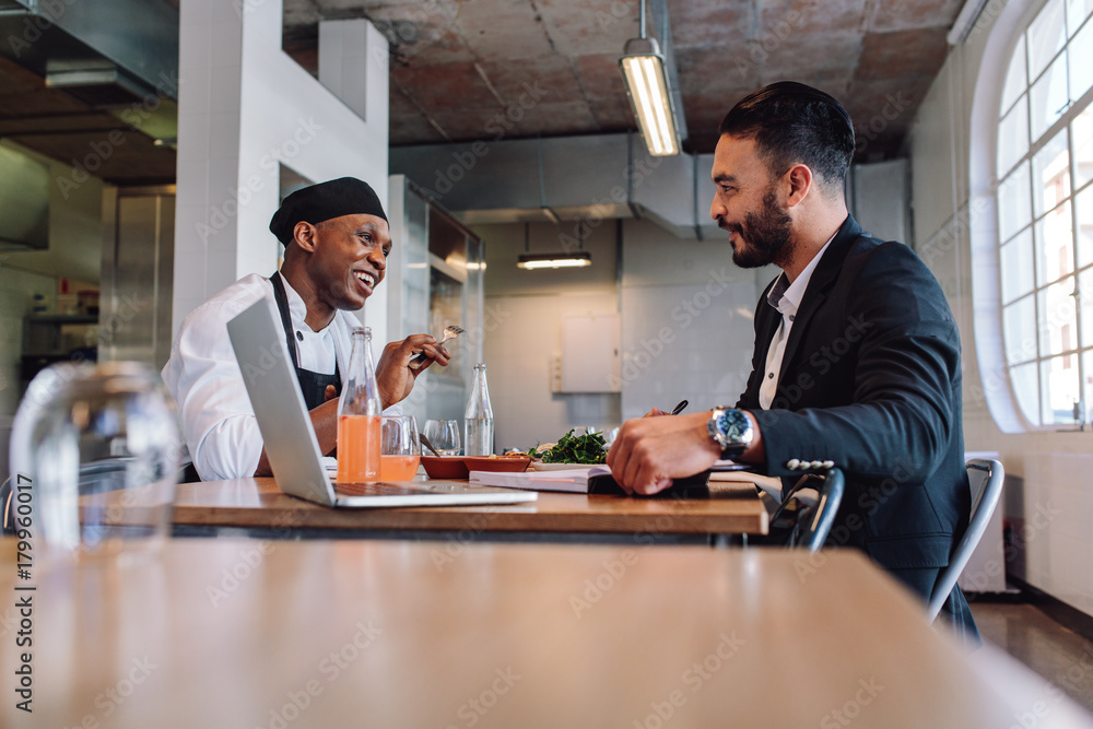 Restaurant manager having a conversation with chef Restaurant manager having a conversation with chef