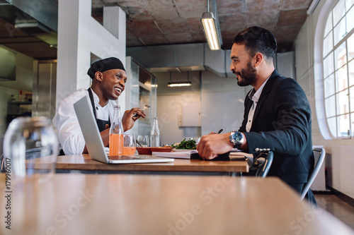Restaurant manager having a conversation with chef