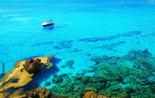 Motor yacht parked in beautiful blue bay. Motor boat in the sea near island Cyprus.