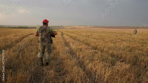 Hunter with shotgun looking for prey.