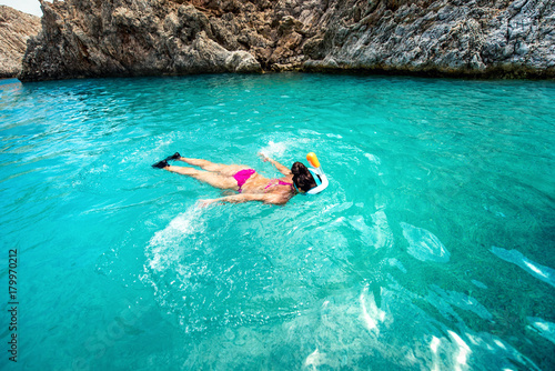 Close up of woman swimming in clear sea water, enjoying snorkeling