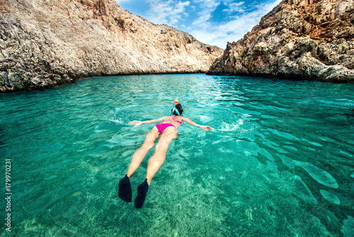 Young woman snorkeling in tropical water. Traveling, active lifestyle concept. Watersports on vacation