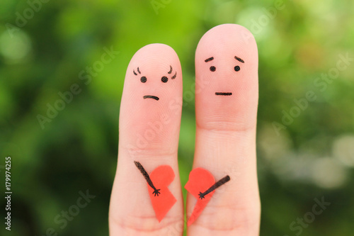 Fotografie Fingers art of sad couple. Woman and man holding broken heart.