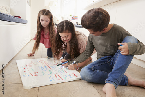 Wallpaper Mural Children Making List Of Chores On Whiteboard At Home