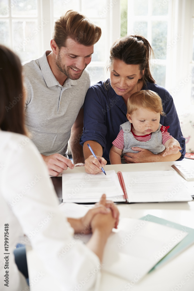 Family With Baby Meeting Financial Advisor At Home Family With Baby Meeting Financial Advisor At Home