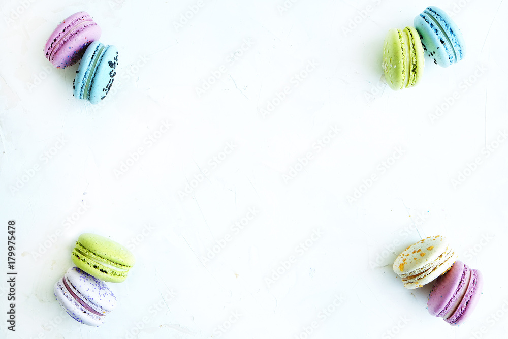 Tasty colorful macaroons in marble background. Text space. Pastel colors. Tasty colorful macaroons in marble background. Text space. Pastel colors.