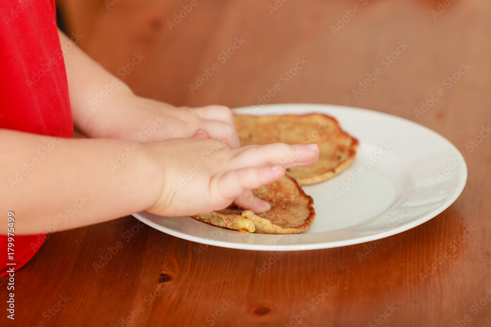 Little boy preparing pancakes for breaktfast