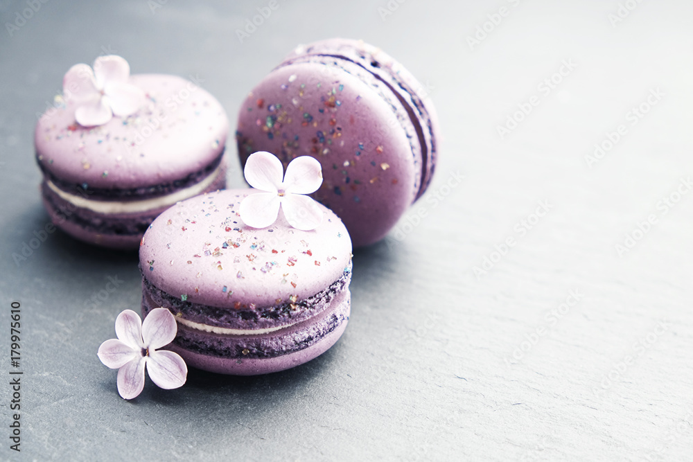 Purple macaroons on graphite table. Sweet macarons. Top view with copy space for your text. Purple macaroons on graphite table. Sweet macarons. Top view with copy space for your text.