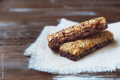 A variety of homemade granola bars  with nuts  raisins dried cherries and  chocolate.