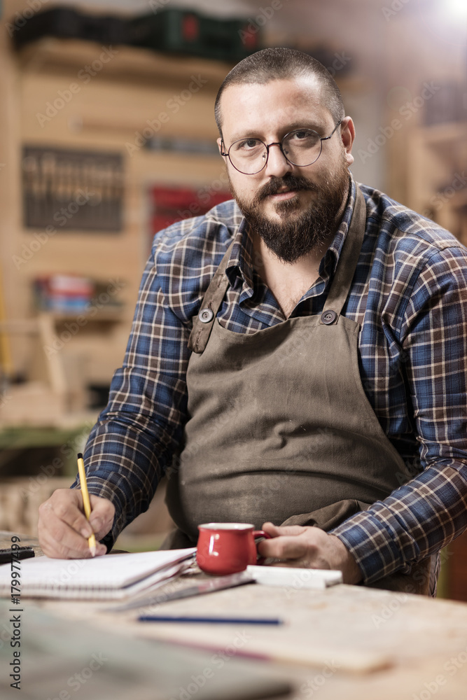 Wood designer working in workshop. Wood designer working in workshop.