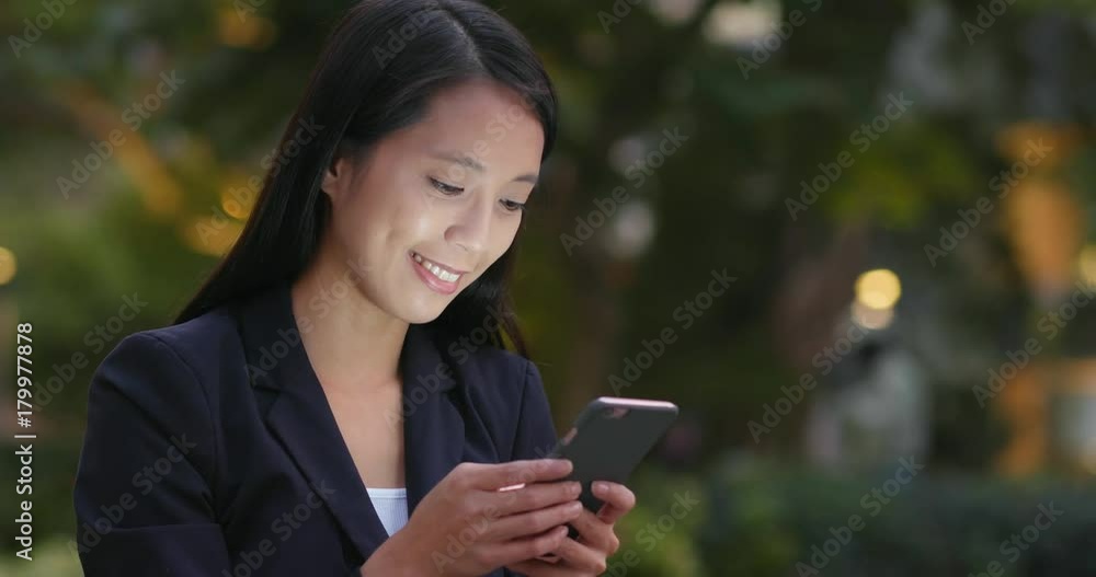 Businesswoman replying client sms on cellphone