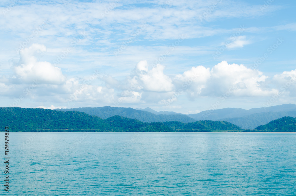Horizontal of Seascape including Forest Mountain, Blue Sky and Wave of Water Foam in Ocean. Horizontal of Seascape including Forest Mountain, Blue Sky and Wave of Water Foam in Ocean.
